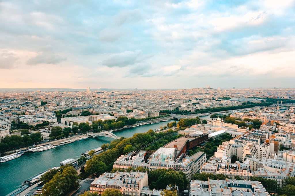 A stunning aerial view of Paris, showcasing the Seine River and iconic landmarks during sunset.
